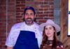 Balvanera Owners to Open Coastal Seafood Restaurant Casa Anchoa in Downtown Chef Fernando Canales in his blue apron and Meredith Boyle from Balvanera stand together in front of a brick wall.