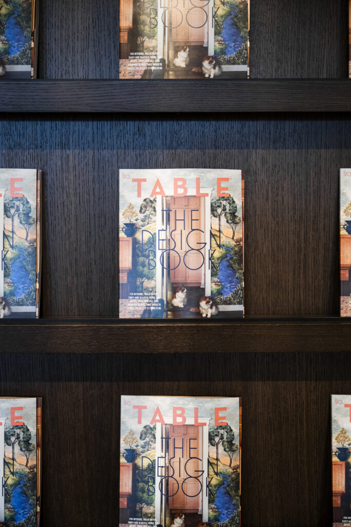 TABLE Magazine's design book sits on a wood display surrounded by others.