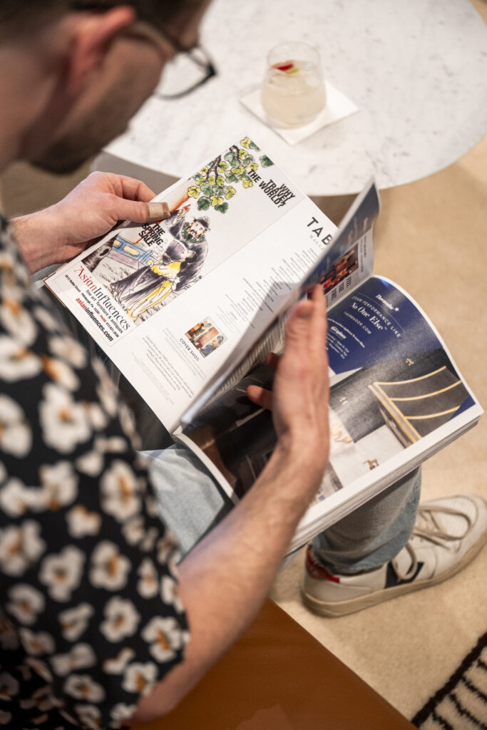 A person flips through TABLE Magazine.