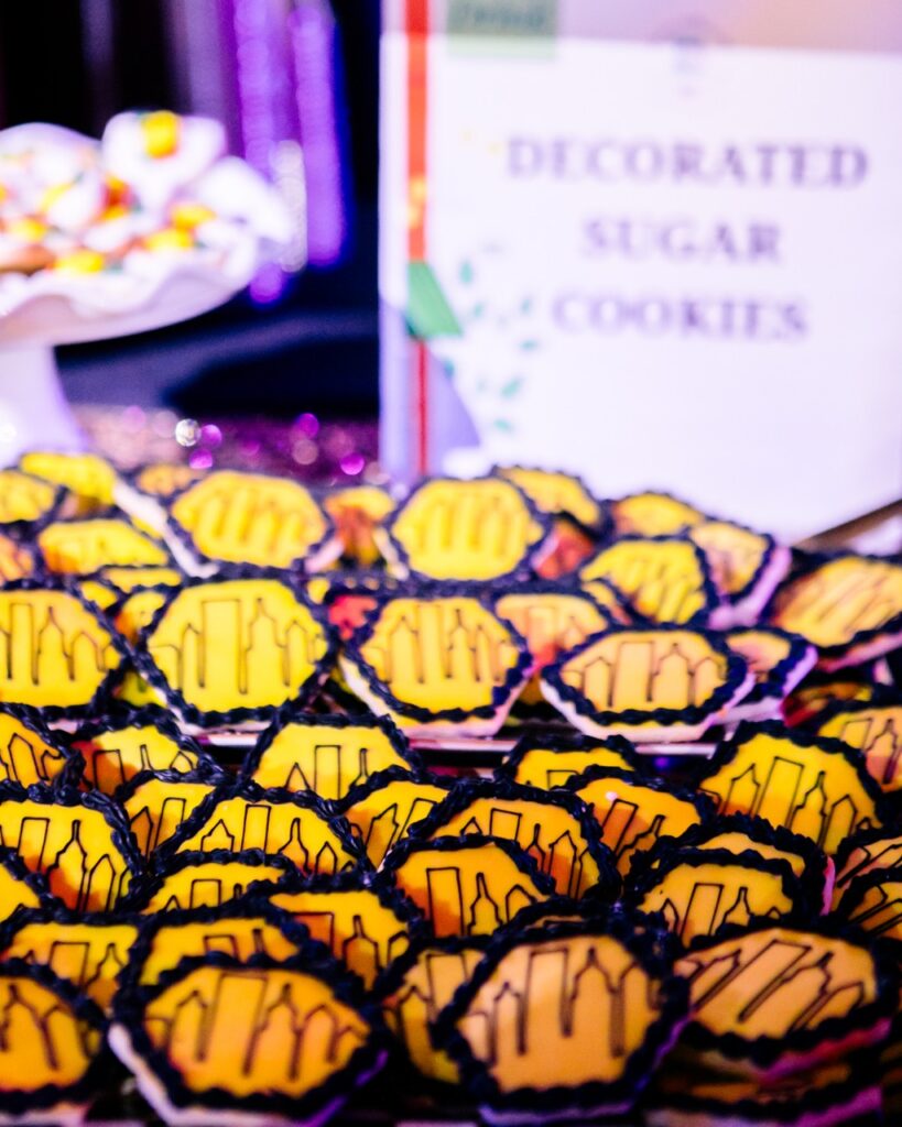 Pittsburgh skyline decorated yellow sugar cookies in an hexagon shape.