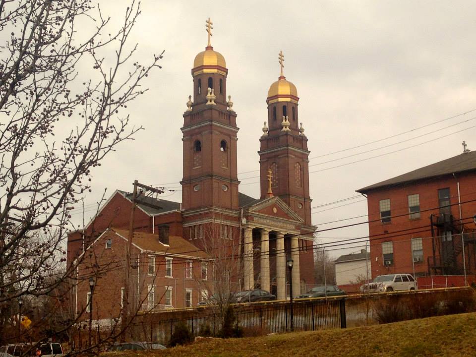 A tall church building in the middle of Braddock.