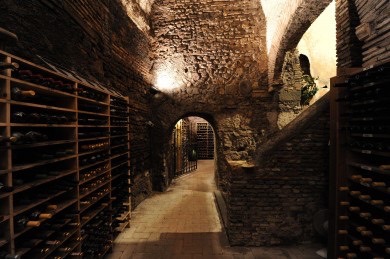 A wine cellar down dark stairs in Rome.