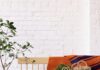 Sara Droz Welcomes Us to Her Spring Haus Pop-Up in Pittsburgh A wood bench with an orange and blue with netted bags on top of it.