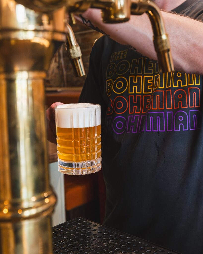 A man pours a czech lager from a tap.