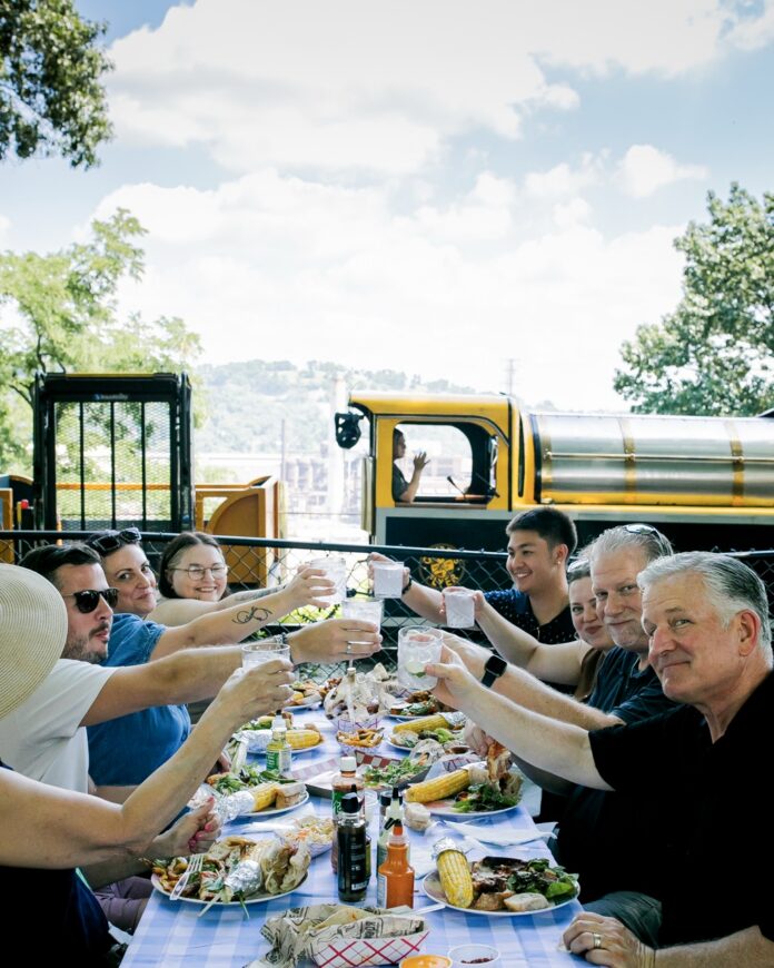 A table of people cheersing glasses.