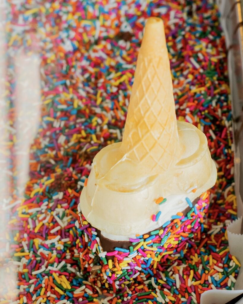 An ice cream cone upside down in sprinkles.