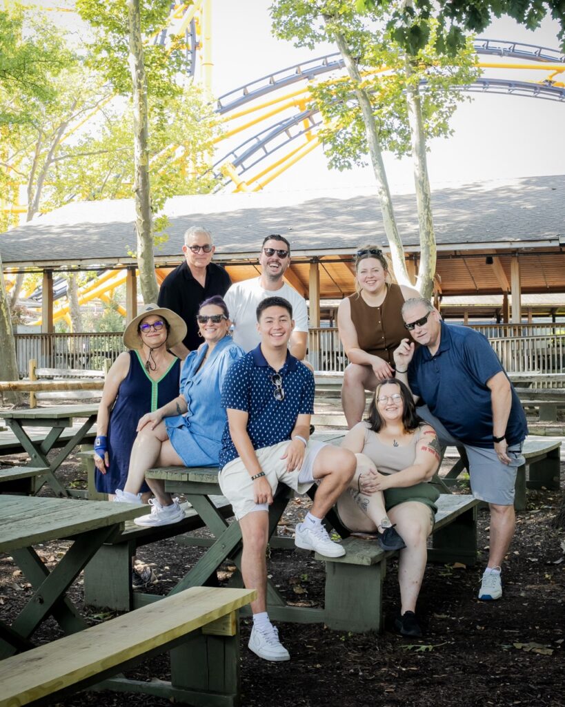 A group of TABLE Magazine workers sitting on a picnic table.