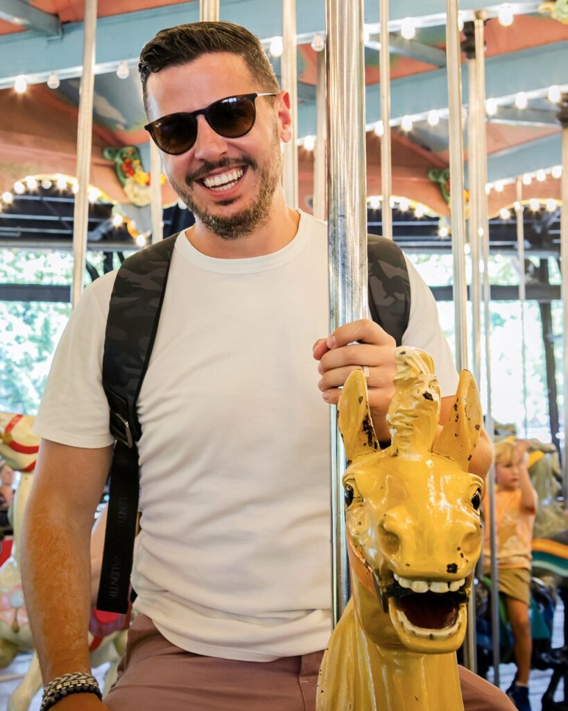 A man on a merry-go-round horse.