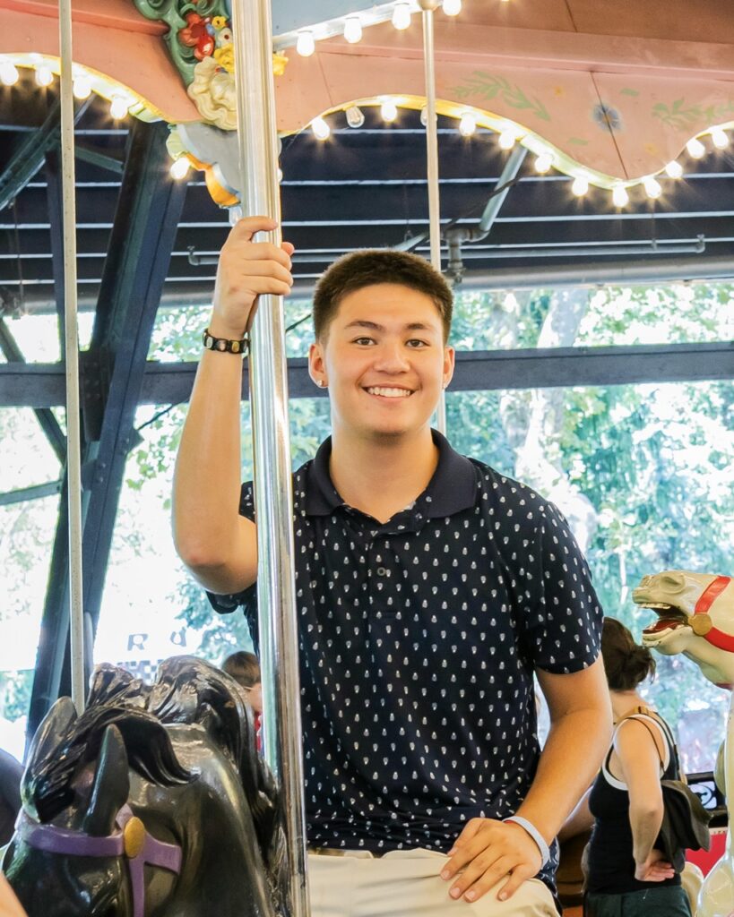 A man on a merry-go-round horse.