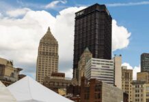 Pittsburgh Markets for Shopping Artisan Art, Food, and More Craft market tents in front of tall buildings in Downtown Pittsburgh.