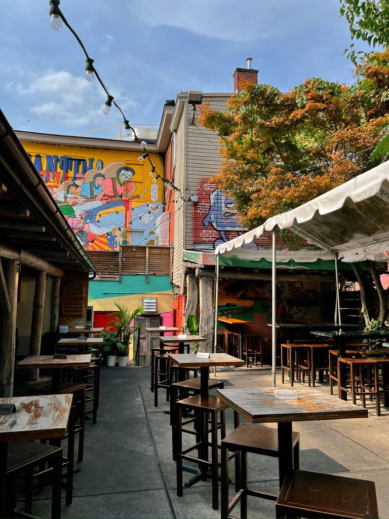 The outdoor tables beside a white tent at a Pittsburgh restaurant.