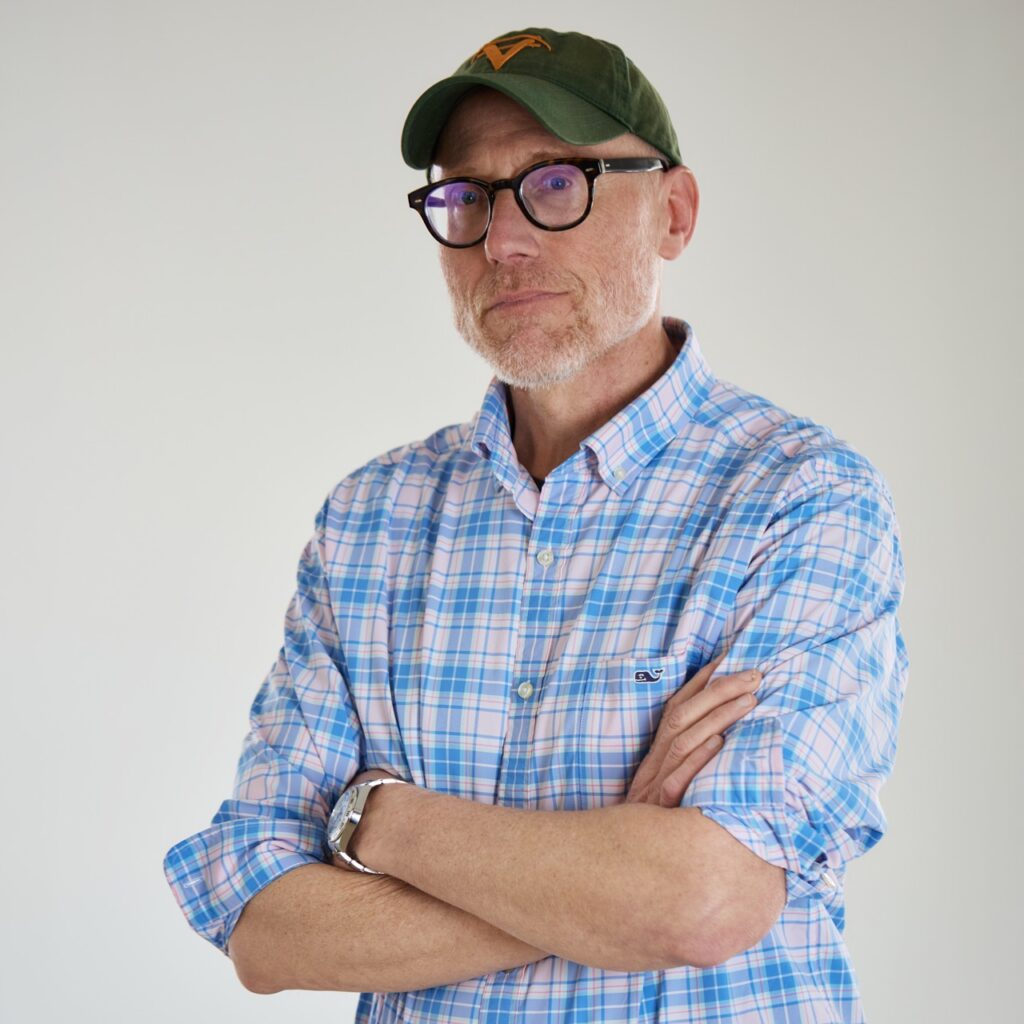 Mike the owner of Virtue Signal with his arms crossed in front of his chest in black glasses and a baseball hat.