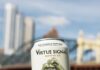 Virtue Signal Brewing Co., Pittsburgh’s New Craft Beer Brand, Has No Alcohol… and That’s the Point A person holds a white can of Virtue Signal beer in front of a bridge in Pittsburgh.