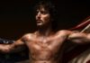 Benson Boone at PPG Paints Arena: What to Know Before You Go Benson Boone shirtless and sort of dirty holding an American flag behind him.