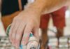The Best Summer Food and Drink Festivals in Pittsburgh A person pours a can of beer into a beers of the burgh festival sampling glass.