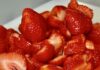 Summer’s Sweetest Weekend at the 50th Annual Burtner House Strawberry Festival A cutting board full of sliced strawberries.