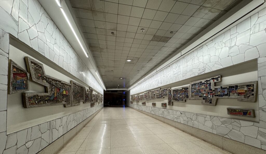 A long hall with sculptures in various shapes tunneling down.