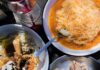 Pittsburgh Chefs Who’ve Stood the Test of Time Three plates of vegan food with pierogies, small samples on another, and a bowl of orange soup with cheese on top.