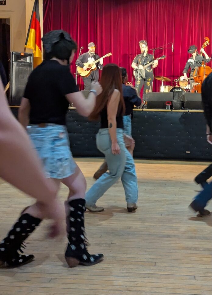 Hot Tickets in Pittsburgh With Sean Collier: July 6-12 People line dancing in Pittsburgh with a live band on the stage.