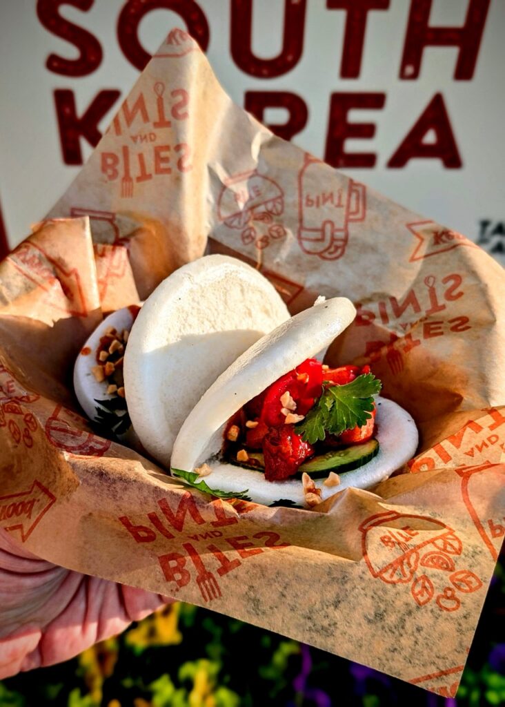 Two bao buns packed with pork belly and veggies.