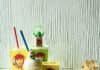 Create a ‘Minions & Monsters’ Feast Thanks to These Pittsburgh Establishments Frostys, drinks, Minion figures, small yellow flowers, a yellow cupcake, a yellow smiley cookie, and a creamy yellow cocktail sit on a table.