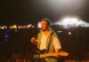 Noah Kahan at PNC Park: What to Know Before You Go Noah Kahan with a guitar playing a concert in front of a large crowd.