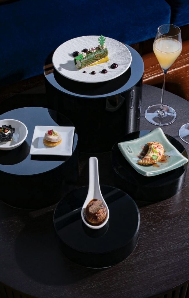 A table set up with small, elegant bites on various plates.