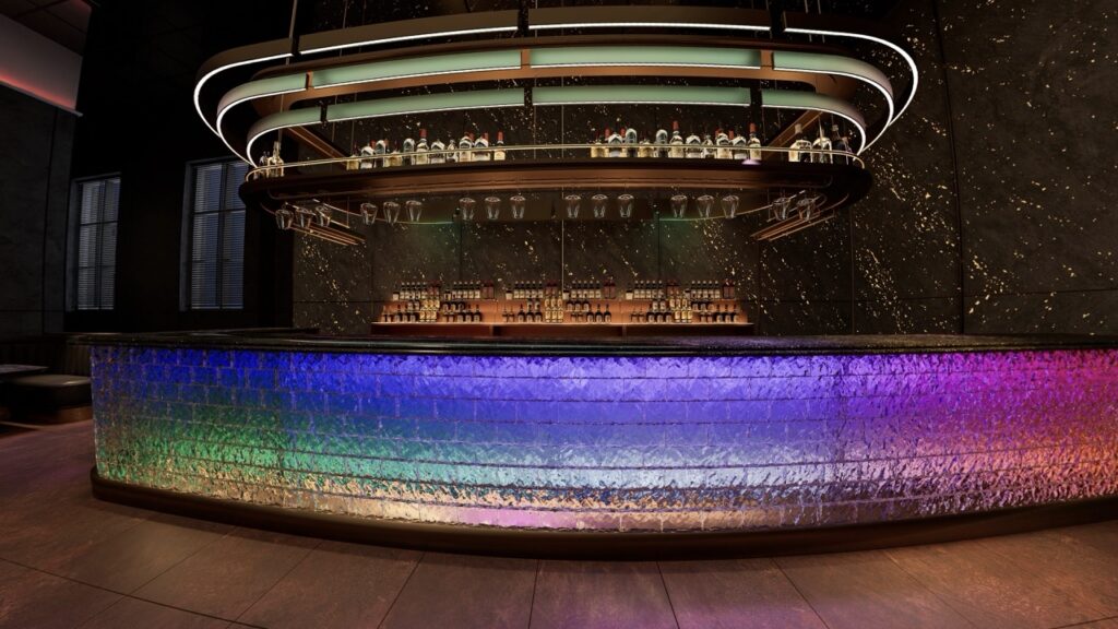 A rainbow bar that's long and rounded with bottles on top of the racks.