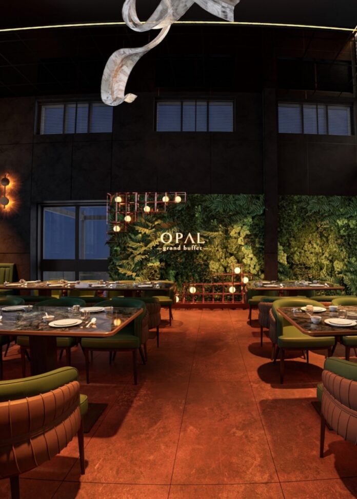 The inside of Opal Buffet with green tables and comfy chairs as well as a wood floor and green wall in the back.