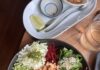 Pittsburgh Summer Restaurant Highlights from Hungry Jess: July 2026 A black bowl full of vegetables in thin slices and grains.