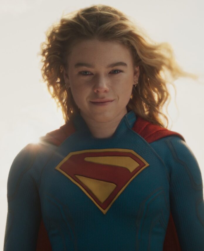 Supergirl TABLE Magazine Supergirl stands in her costume with her hair blowing back and the sun glowing around her.