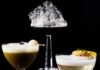 Pittsburgh Bartenders Test Their Creativity in TABLE Magazine’s 2nd Annual Cocktail Shake-Off A black cocktail with foam on a top podium, a green cocktail on the second podium, and a clear cocktail with foam on the bottom podium.
