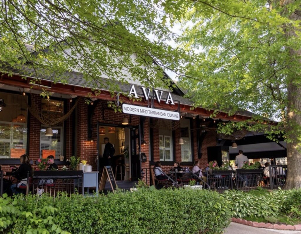 The outside of AVVA restaurant with porch dining.