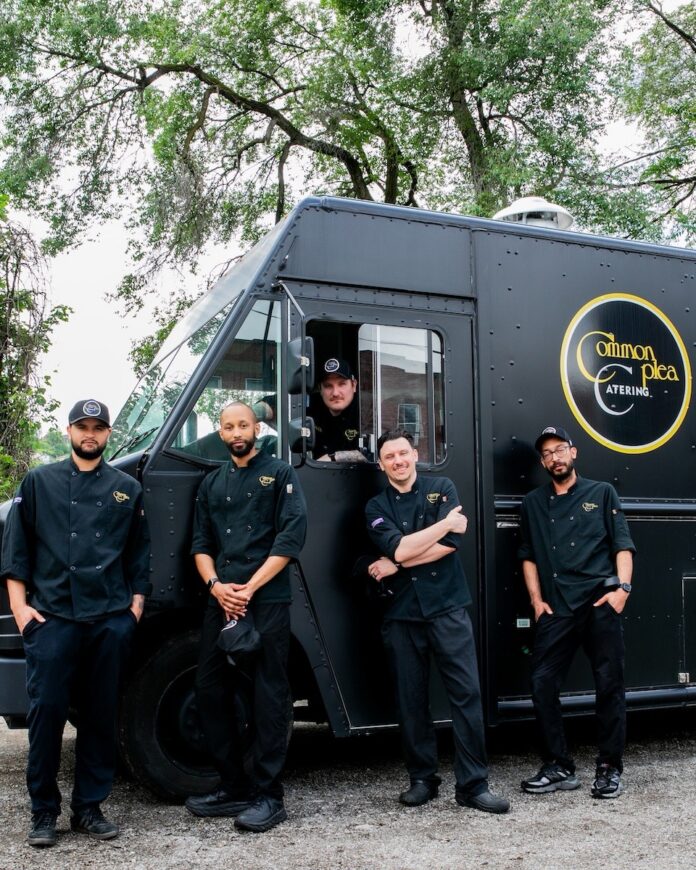 Meet the Team Behind Common Plea Catering's Unforgettable Event Services: Head of the Table, July 2026 The Common Plea Catering culinary team stands with four members in black outside the catering truck and one member in the drivers seat of the truck.