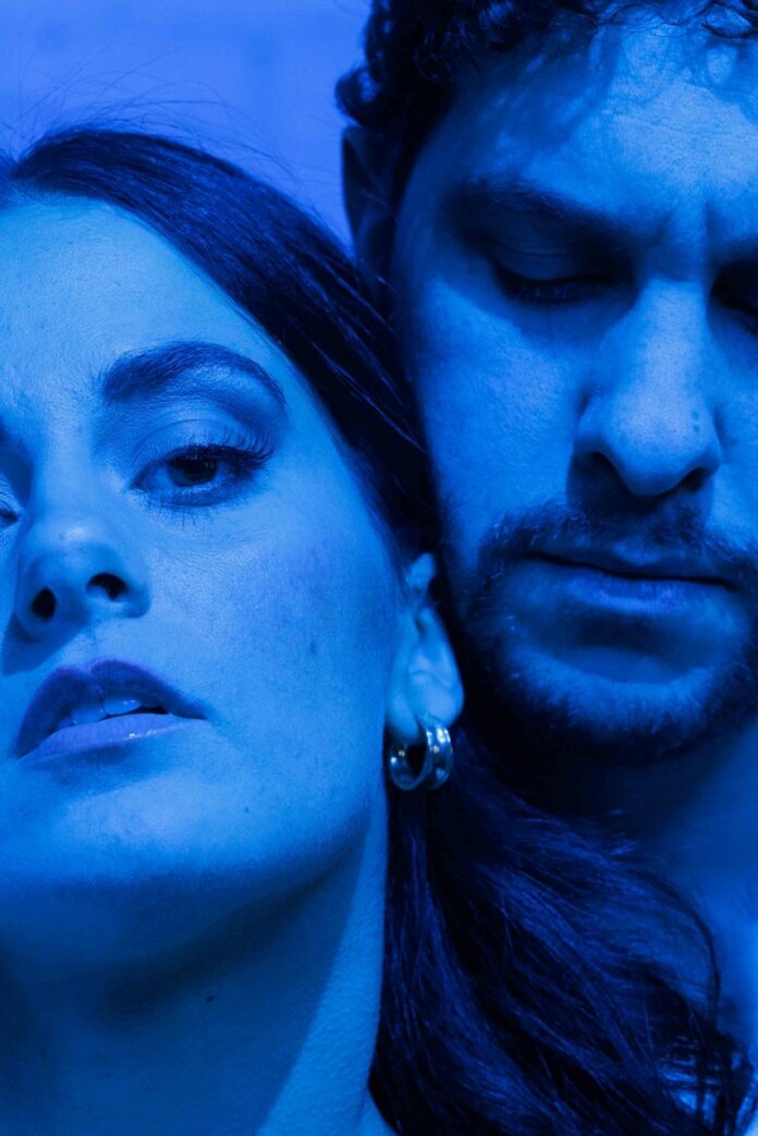 Pittsburgh's Independent Theater Scene Is Thriving With 'Danny and the Deep Blue Sea' Up close faces of a man and a woman, the woman looking at the camera and the man looking down in blue lighting.