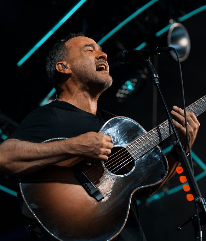 Dave Matthews Band at The Pavilion at Star Lake: What to Know Before You Go Dave Matthews plays an acoustic guitar and sings into a mic on stage.
