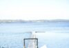Escape to Whidbey Island: This Rustic Waterfront Inn Has Welcomed Guests Since 1907 A dock leading out to a lake with a small yellow shack beside it.