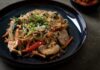 The I-376 Closure Survival Guide: Where to Eat Along the Detour A plate of Chinese stir fry with chicken and vegetables on a table.