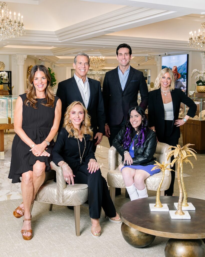The Louis Anthony Jewelers family sit together in the showspace all in black elegant clothing.