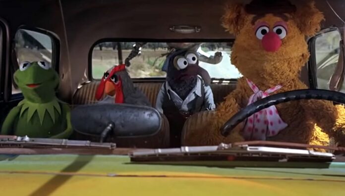 Fozzie, kermit, gonzo, and camilla the muppets in a car driving.