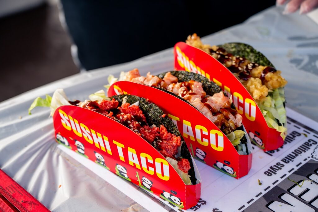Three sushi tacos in holders.