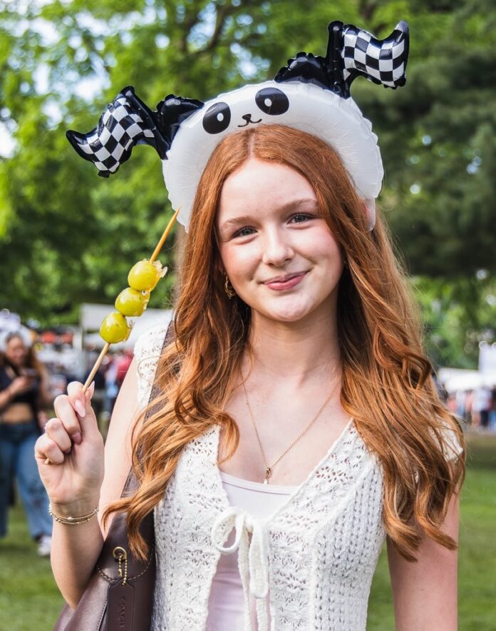 Panda Fest Pittsburgh TABLE Magazine 6 A girl in a panda headband holding Tanghulu in her hand.