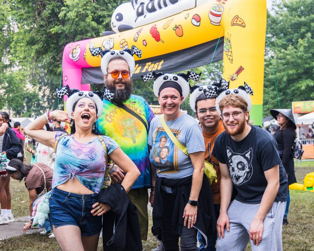 A group of people with panda headbands on.
