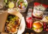 The Best Pittsburgh Boxed Lunches for Effortless Entertaining A table full of boxed lunches with sandwiches, chips, drinks, and cold sides.
