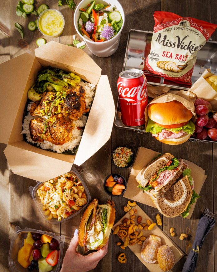 Pittsburgh Best Boxed Lunches TABLE Magazine 4 A table full of boxed lunches with sandwiches, chips, drinks, and cold sides.