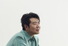Pittsburgh Classical Concerts to See This Fall (August-September 2026) Lang Lang in a blue button up shirt leaning over a black piano.