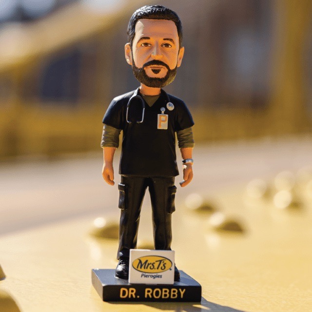 A Dr. Robby bottle head on a yellow bridge.