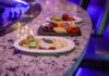 Don’t Miss Two More Chances to Join the Sip & Social Craze at Rivers Casino Pittsburgh Two plates of Italian food with a small charcuterie board between them sitting on a rounded marble counter.