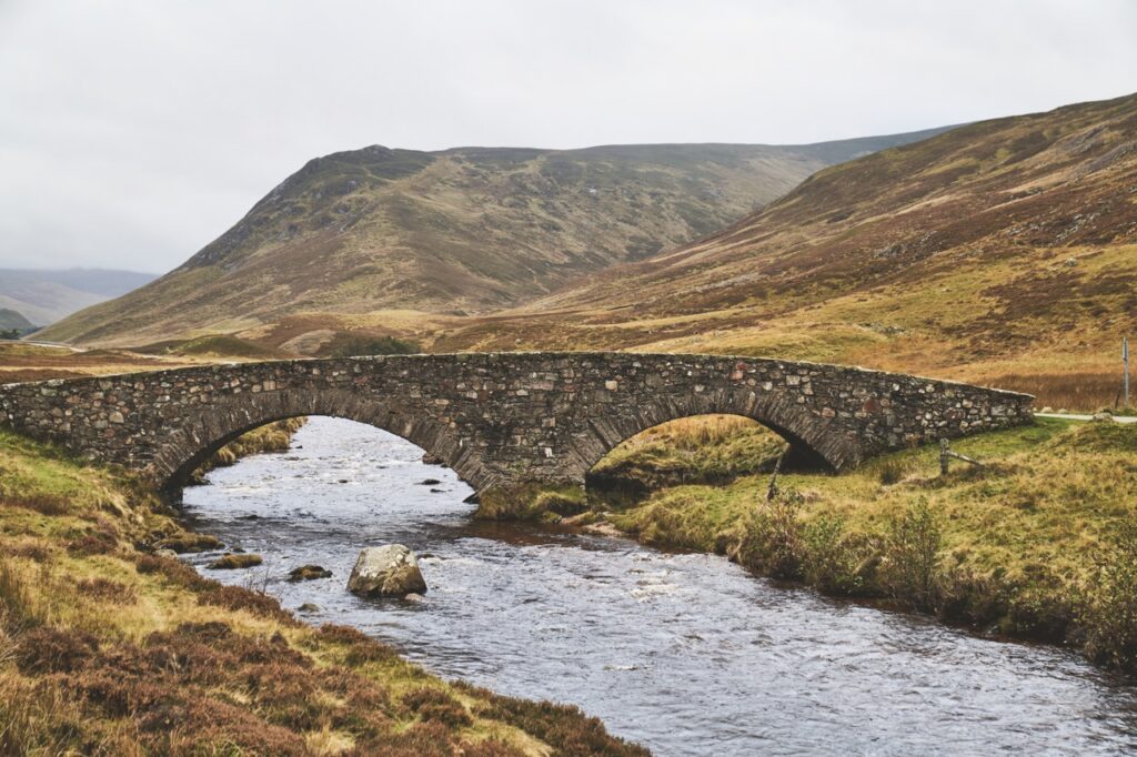 A bridge connecting hills over water in the Scottish Highlands.