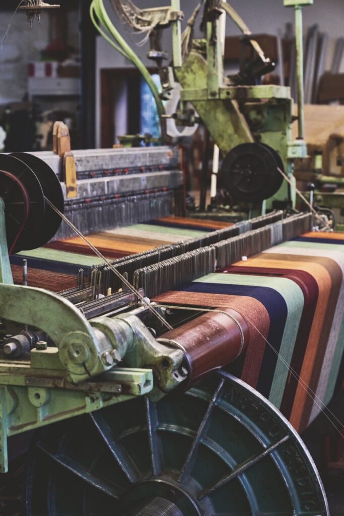 A sewing machine with many colors of thread wound up.